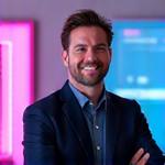 Professional headshot of Alex 'Synthwave' Reed, CEO and Co-Founder